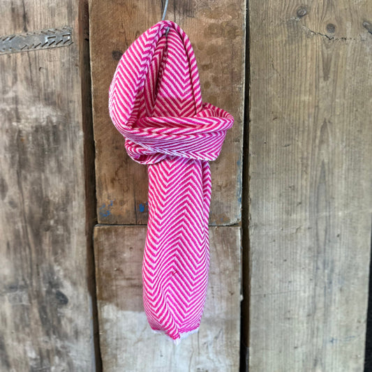 Pink and white scarf on wooden background