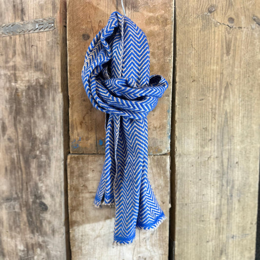Blue and white patterned scarf tied on a wooden surface